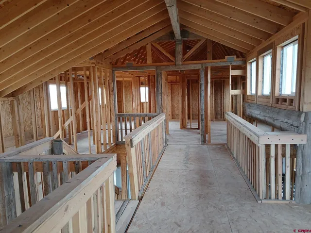 a view of a porch with wooden floor and front door