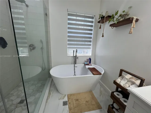 a white bath tub sitting next to a white sink