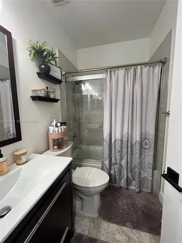 a bathroom with a sink a toilet and a shower