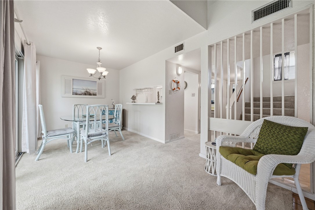 2003 North Fulton Beach Road, Unit 34 34 Rockport, TX 78382 - Photo 6 of 38 a living room with furniture and a chandelier