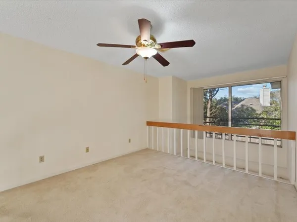 a view of an empty room with a fan