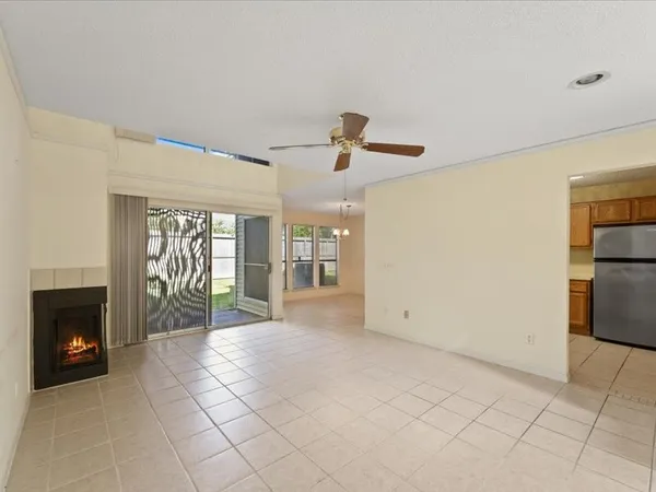 a view of an empty room with a fireplace and a window