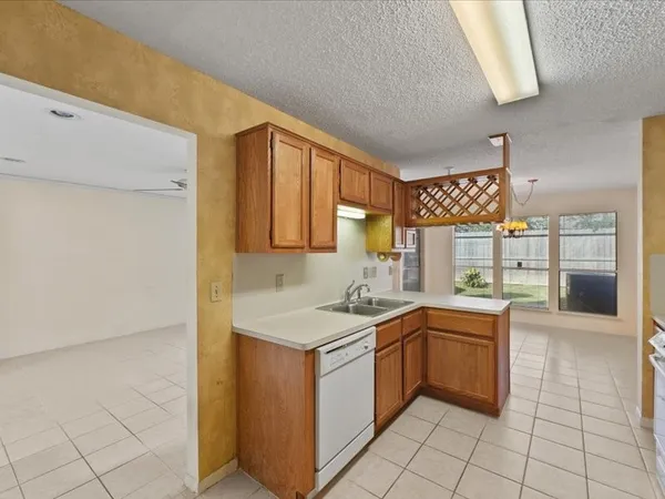 a kitchen with a refrigerator and a stove