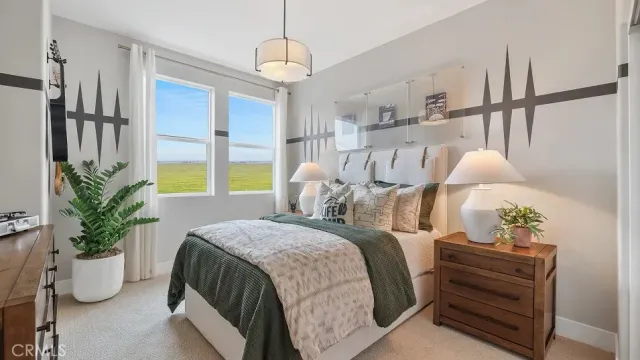 a bedroom with a bed and a potted plant