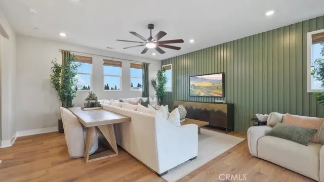 a living room with furniture a chandelier and a window
