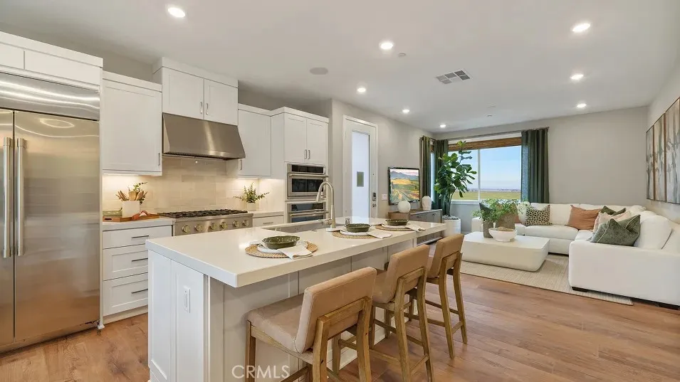 1022 Currant Road Fullerton, CA 92835 - Photo 2 of 25 a kitchen with stainless steel appliances kitchen island granite countertop a stove a sink a dining table and chairs