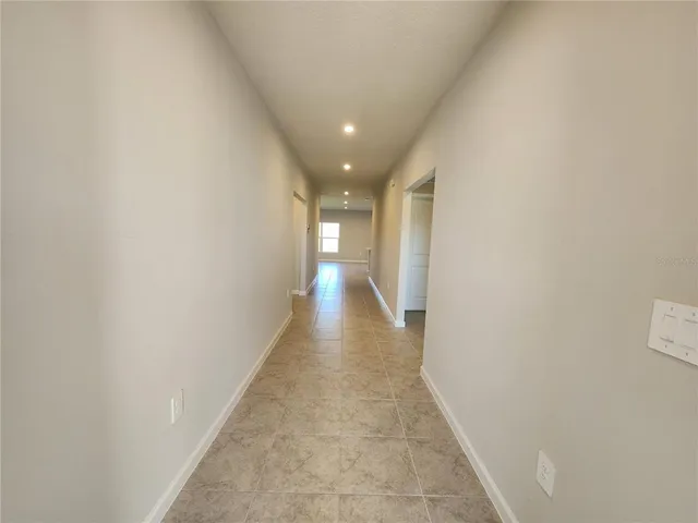 a kitchen with a refrigerator a stove and white cabinets