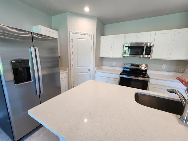 a view of a livingroom with workspace and a window