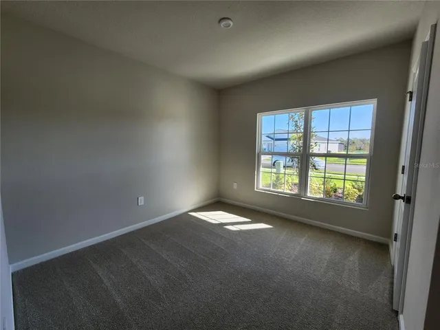 an empty room with closet and a bathroom