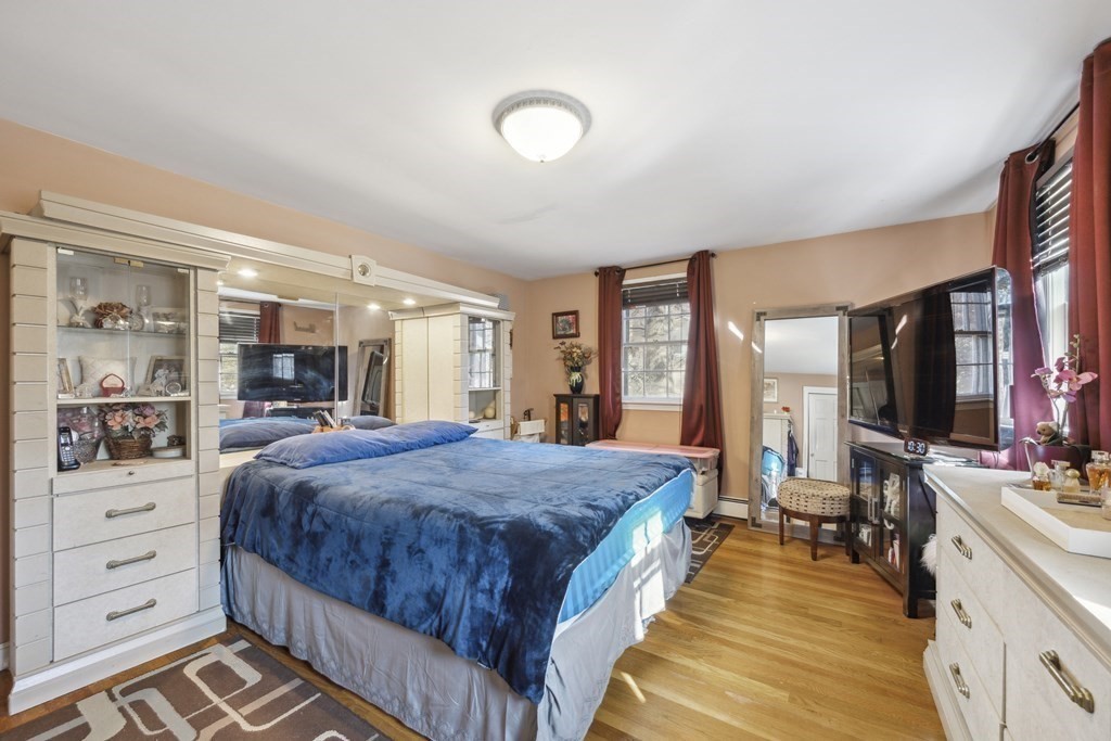 8 Robert Plunkett Circle Randolph, MA 02368 - Photo 11 of 22 a spacious bedroom with a large bed and a flat tv screen