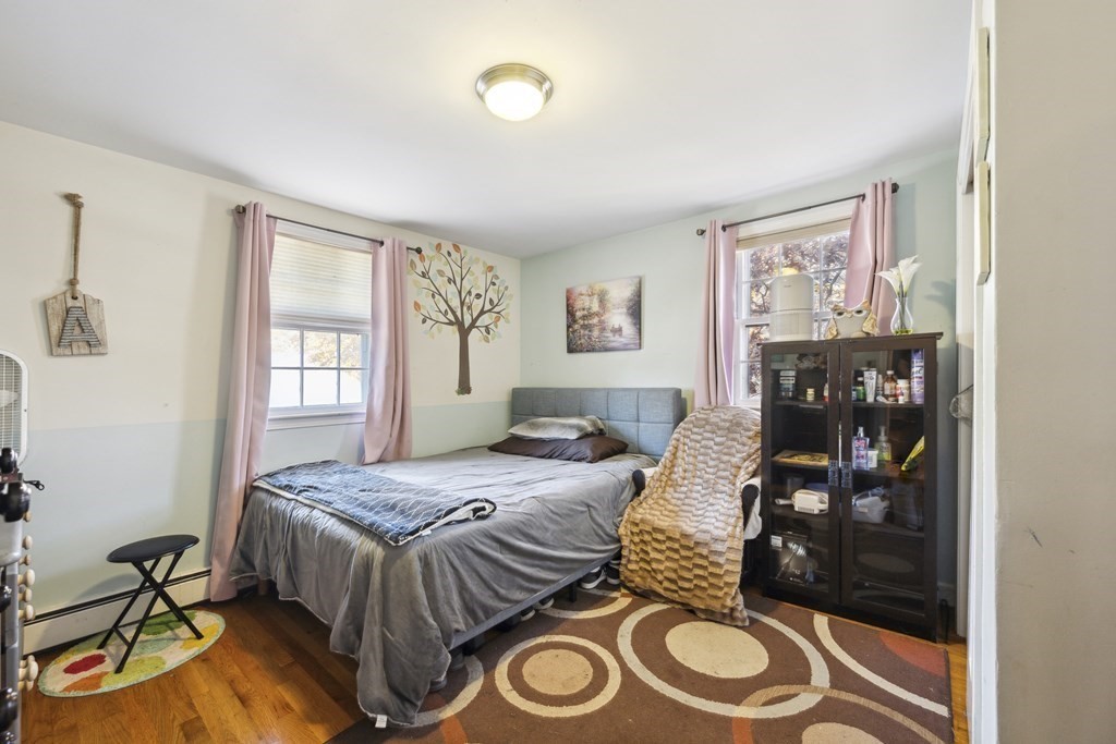 8 Robert Plunkett Circle Randolph, MA 02368 - Photo 14 of 22 a bedroom with a bed and wooden floor