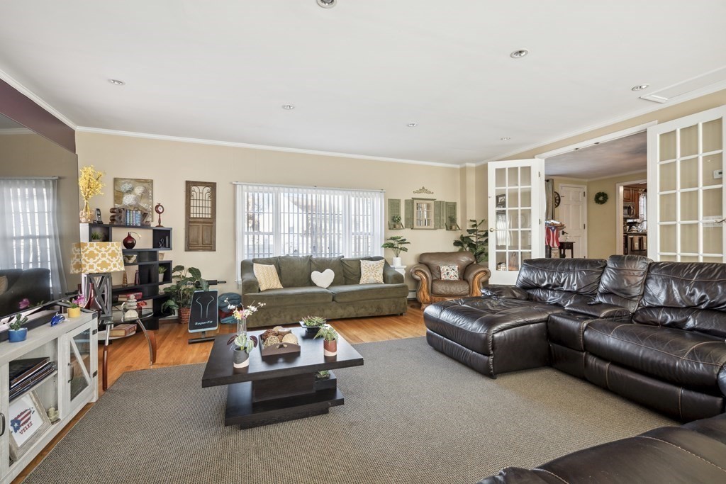 8 Robert Plunkett Circle Randolph, MA 02368 - Photo 17 of 22 a living room with furniture large window and a wooden floor