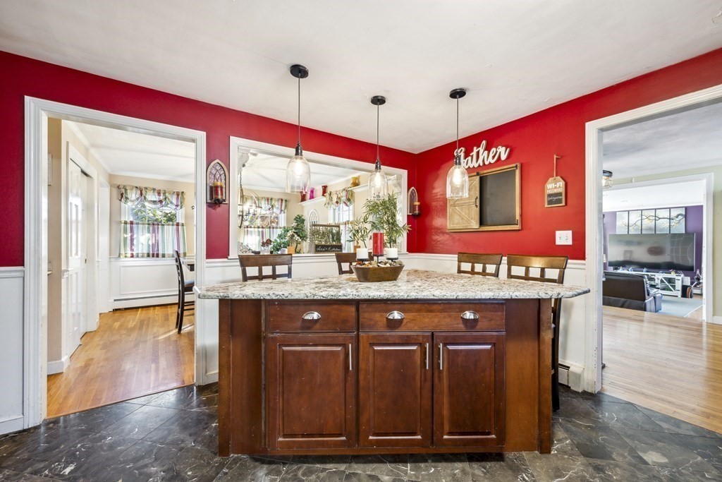 8 Robert Plunkett Circle Randolph, MA 02368 - Photo 10 of 22 a spacious kitchen with stainless steel appliances granite countertop a sink and a wooden cabinets