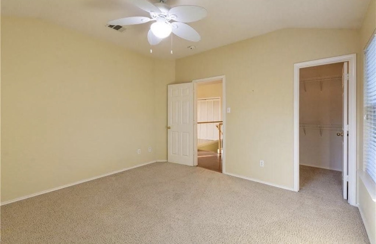 1900 Scofield Ridge Parkway, Unit 3101 Austin, TX 78727 - Photo 18 of 24 Carpeted room featuring a ceiling fan with integrated lighting, vaulted ceiling, and ample natural light from window blinds