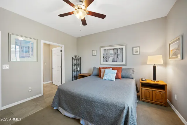 a bedroom with a large bed and a chandelier