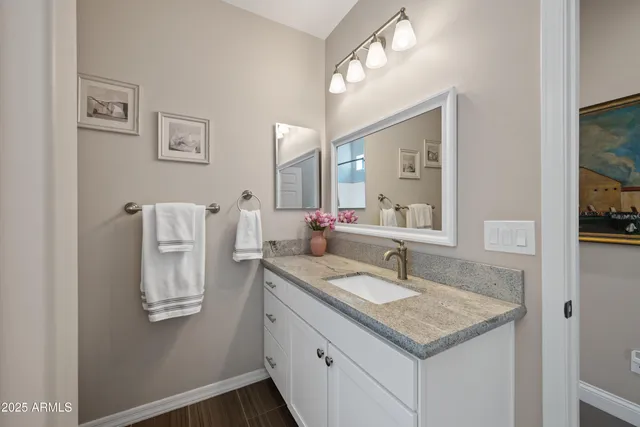 a bathroom with a granite countertop sink a toilet and bathtub
