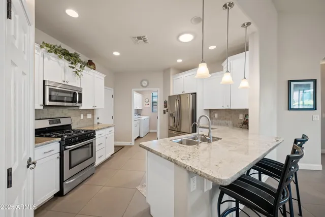 a living room with furniture and a view of kitchen