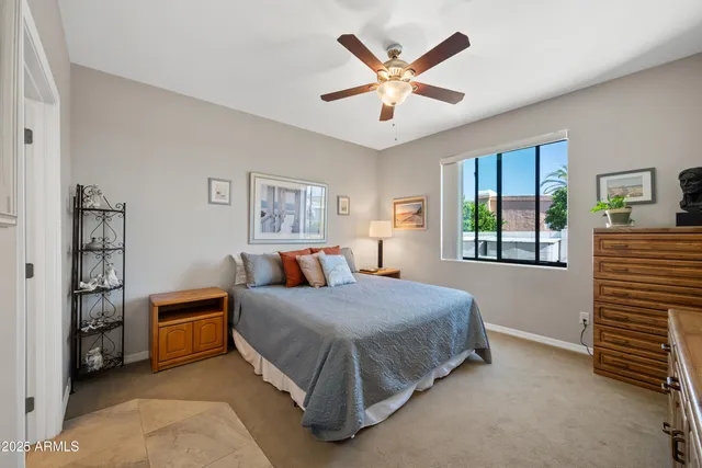 a dining room with furniture a chandelier and a flat screen tv
