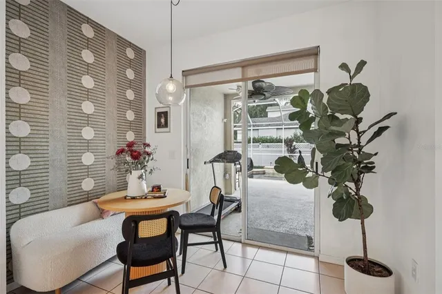 a dining room with furniture and potted plant