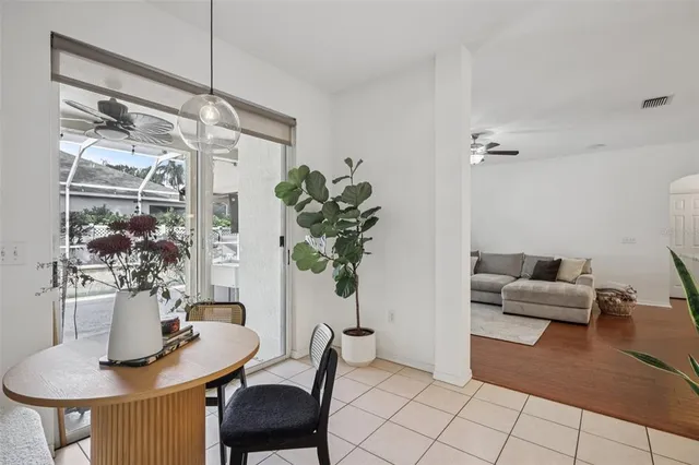 a dining room with furniture and wooden floor