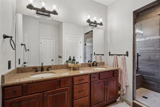 a bathroom with double sink and a mirror