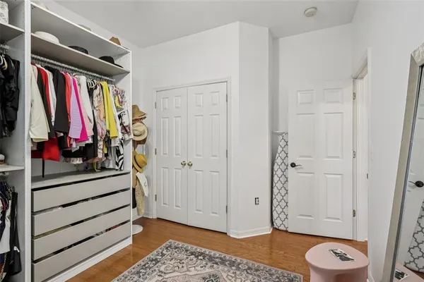 a view of walk in closet with clothes and shoes
