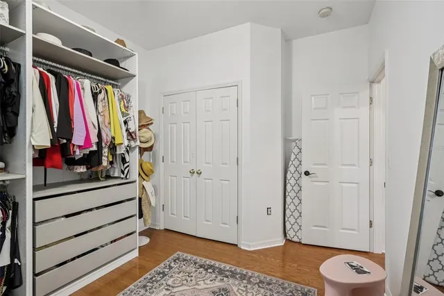 a view of walk in closet with clothes and shoes