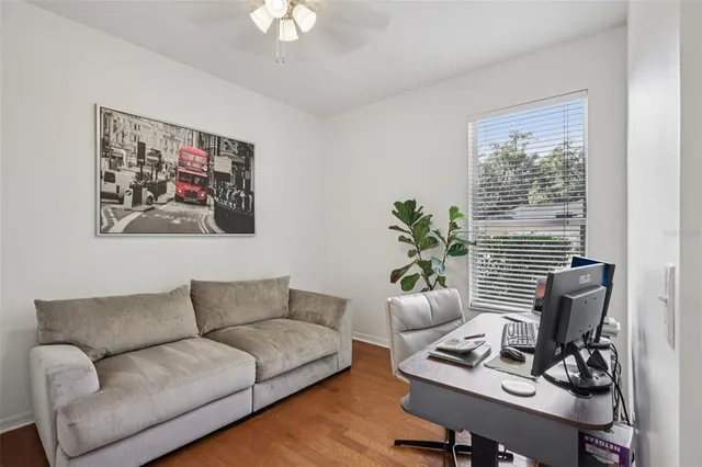 a living room with furniture and a potted plant