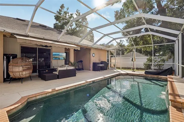 a view of a swimming pool with outdoor seating