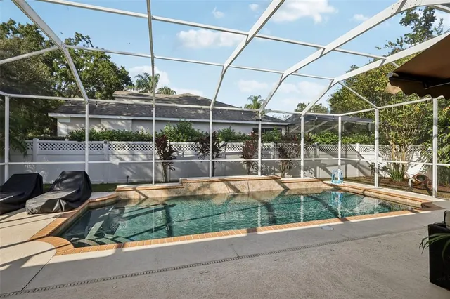 a view of a house with a backyard and a tub