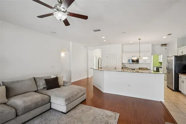 a living room with furniture and kitchen view