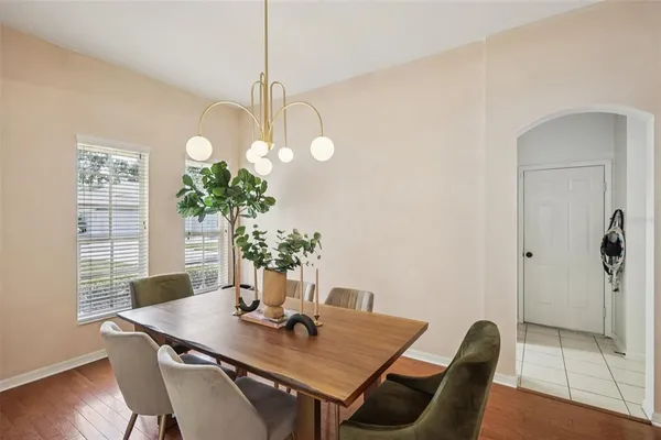 a view of a dining room with furniture wooden floor and chandelier