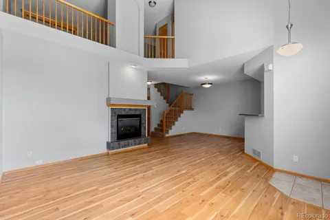 a view of a livingroom with wooden floor and a ceiling fan