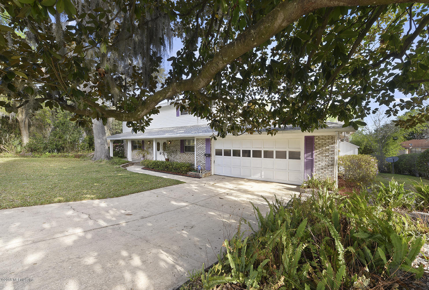 6511 Ferber Road Jacksonville, FL 32277 - Photo 3 of 27 a front view of a house with a garden