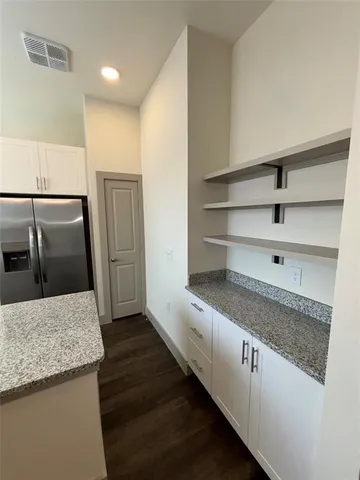 a view of kitchen and hall with wooden floor