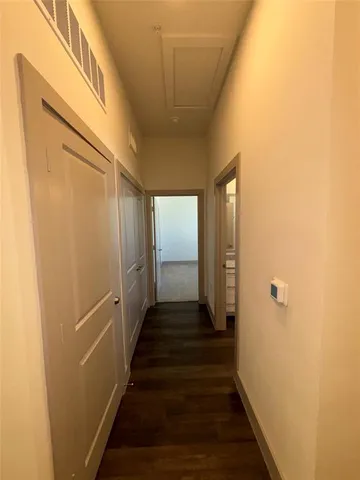 an entryway in a hall with wooden floor