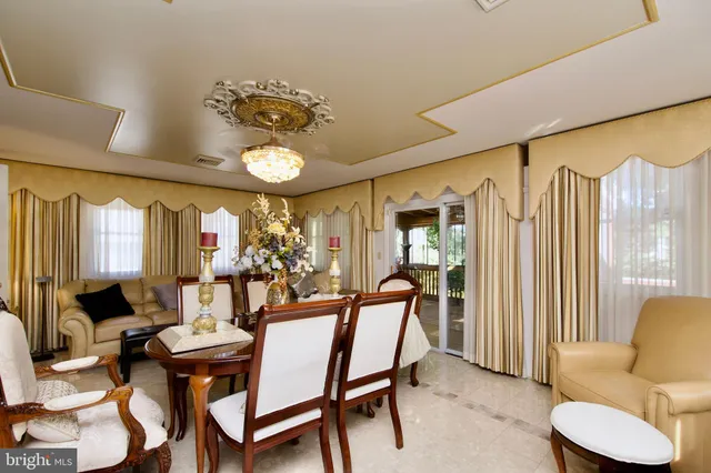 a view of a dining room with furniture and a large window