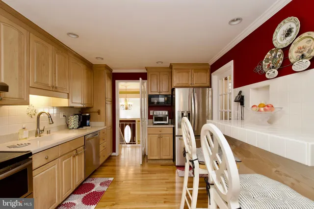 a kitchen with stainless steel appliances granite countertop a refrigerator and a stove top oven