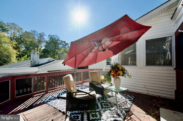 a view of a patio with table and chairs under an umbrella