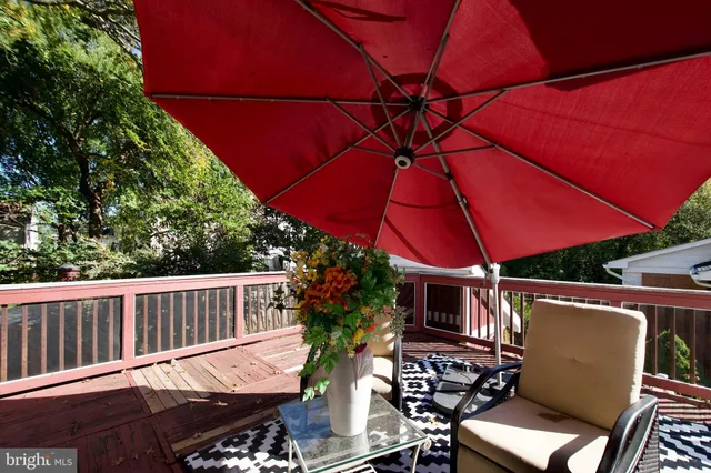 a view of a patio with table and chairs under an umbrella