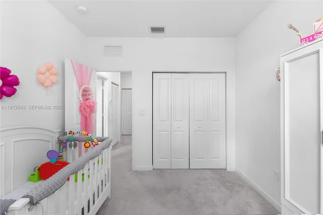 a picture of a swimming pool with a yard and plants