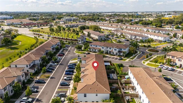 an aerial view of a house with a yard and lake view