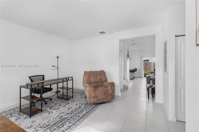 a living room with furniture and a rug