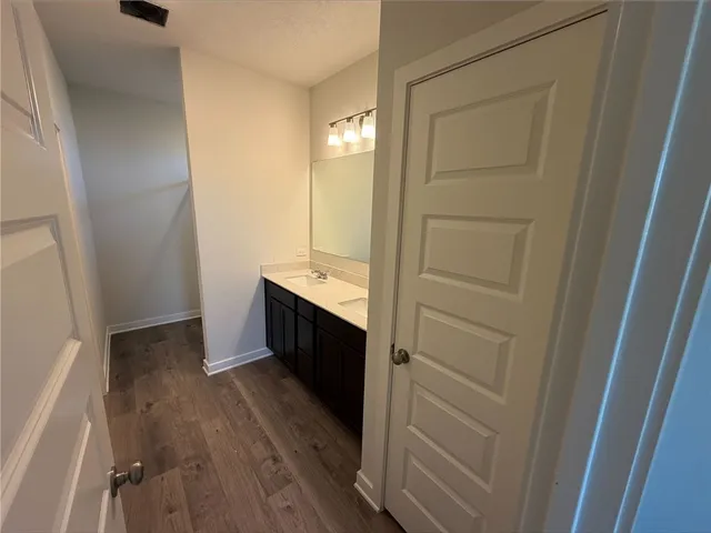 a kitchen with kitchen island granite countertop a sink and a refrigerator