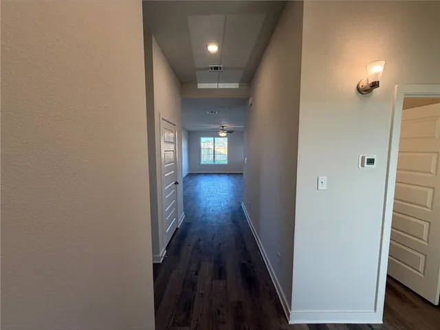 a view of hallway with wooden floor