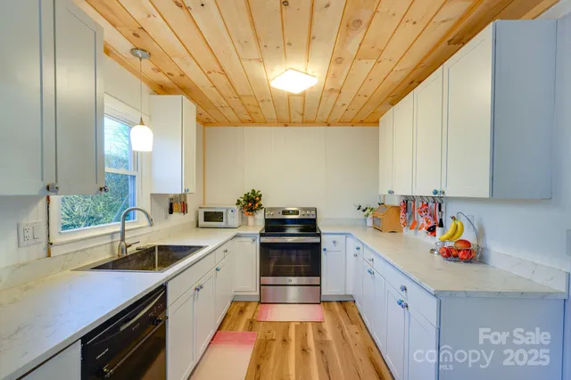 a view of a kitchen with a sink and cabinets