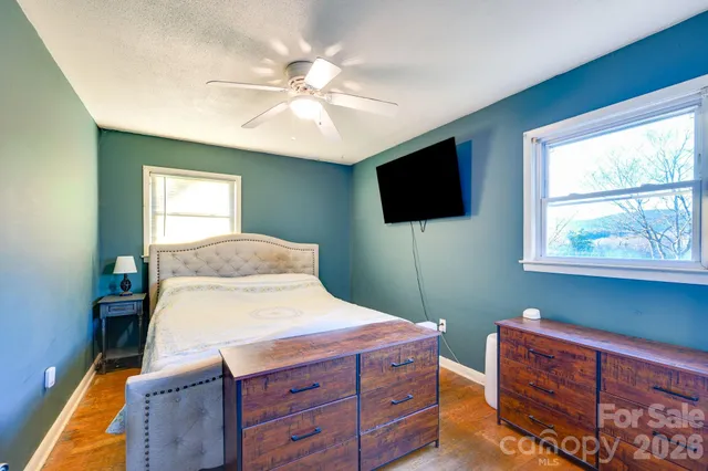 a bedroom with a bed and a chandelier