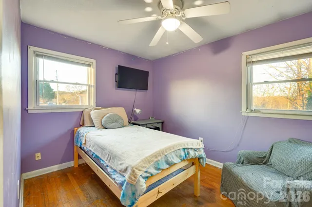 a bedroom with a bed and ceiling fan