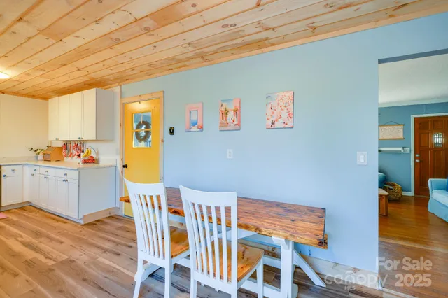 a dining room with furniture and wooden floor