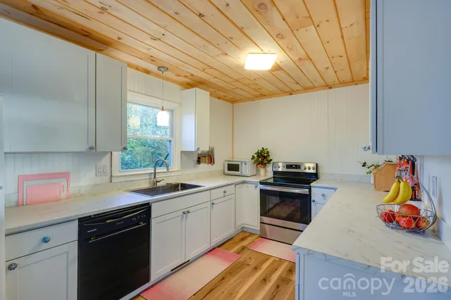 a kitchen with stainless steel appliances granite countertop a sink and cabinets